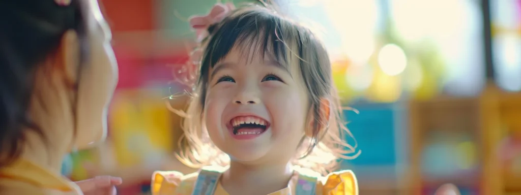 a cheerful child receiving a warm, encouraging smile from their caregiver during a playful activity at daycare.